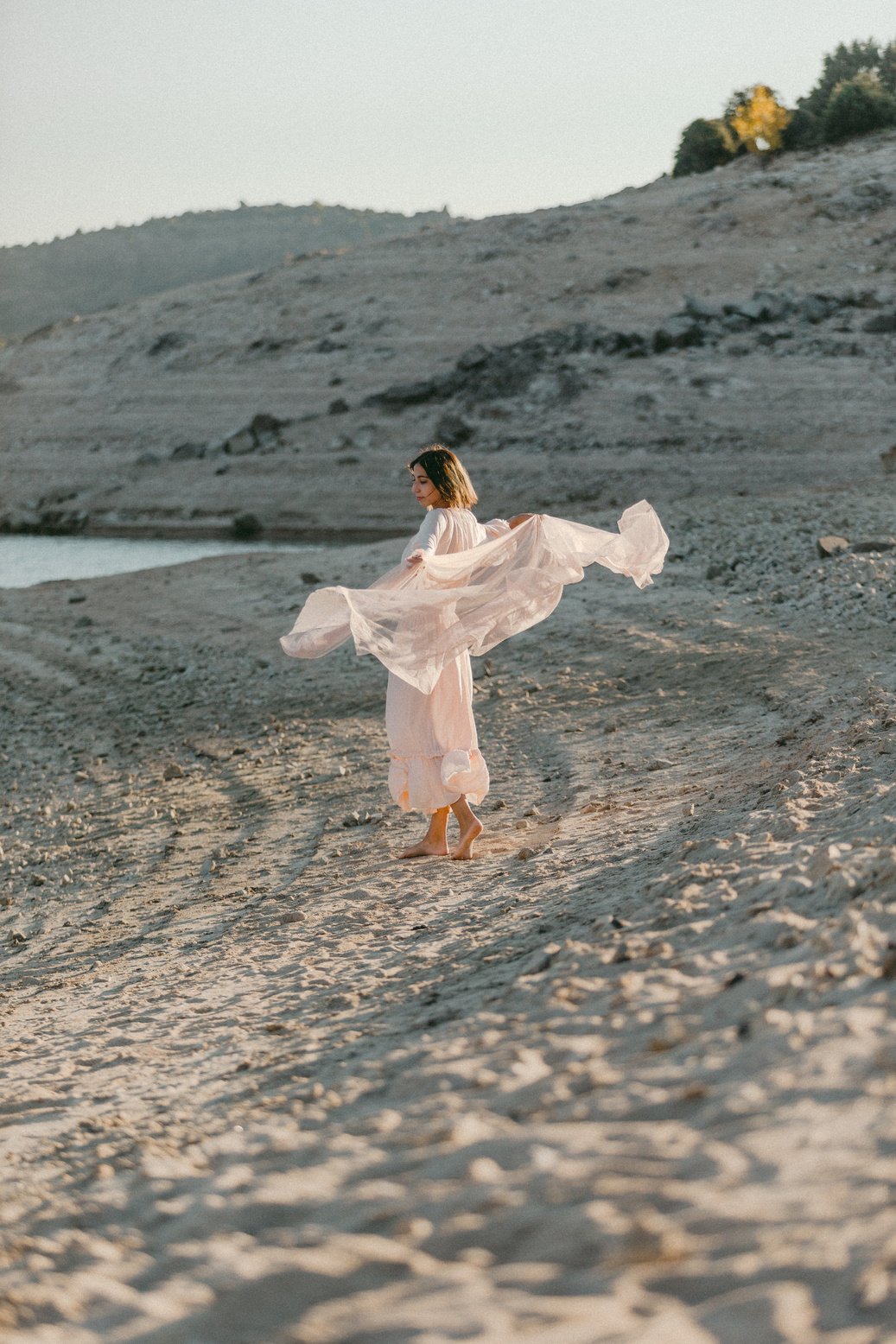 Woman in Sheer Dress and Scarf at the Beach